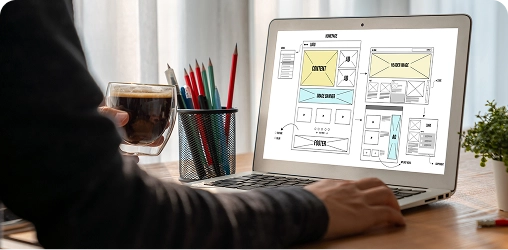 Homepage Design Discussion Laptop displaying homepage wireframes used by BrandLoom to redesign Manappuram’s homepage for a better UX.