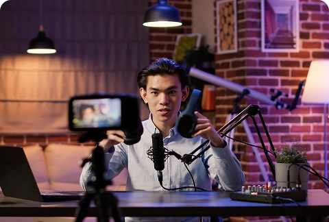 Content creator filming a video using a professional camera setup, microphone, and lighting for video and audio advertising Content creator filming a video using a professional camera setup, microphone, and lighting for video and audio advertising