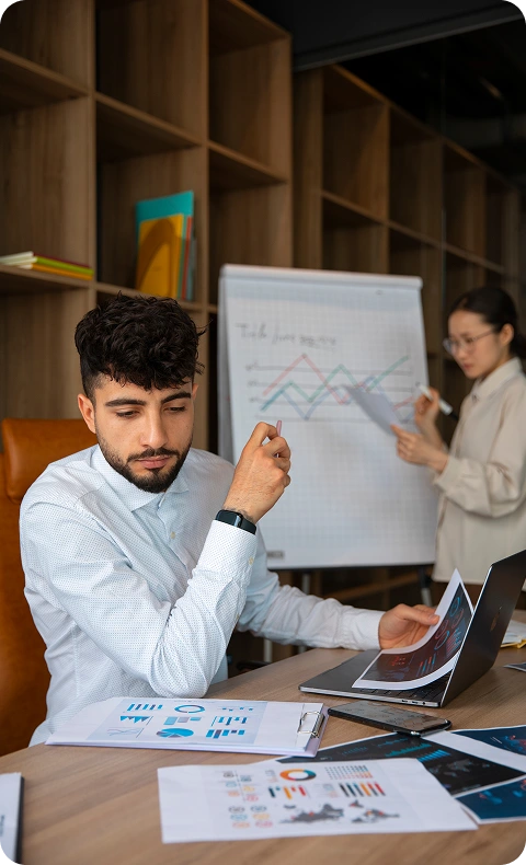 Team analyzing marketing charts and data during a programmatic advertising strategy meeting Team analyzing marketing charts and data during a programmatic advertising strategy meeting