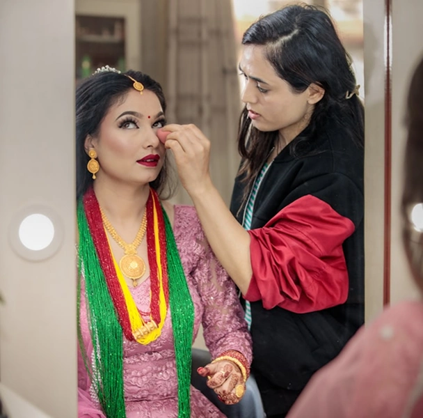 Makeup artist applying bridal makeup during Diya Sharma Hair and Studio content shoot Makeup artist applying bridal makeup during Diya Sharma Hair and Studio content shoot