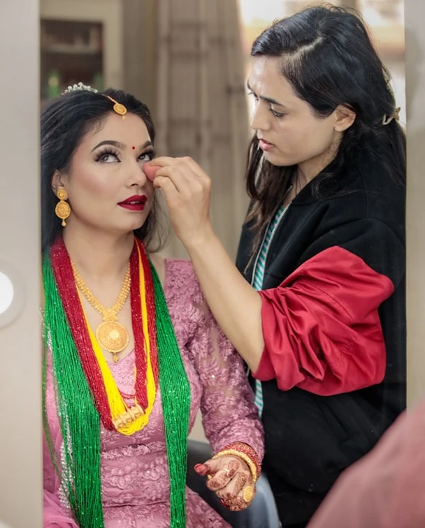 Makeup-artist-applying-bridal-makeup-during-Diya-Sharma-Hair-and-Studio-shoot.webp